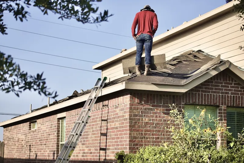 Professional roofer working on a residential roof in Prestonwood